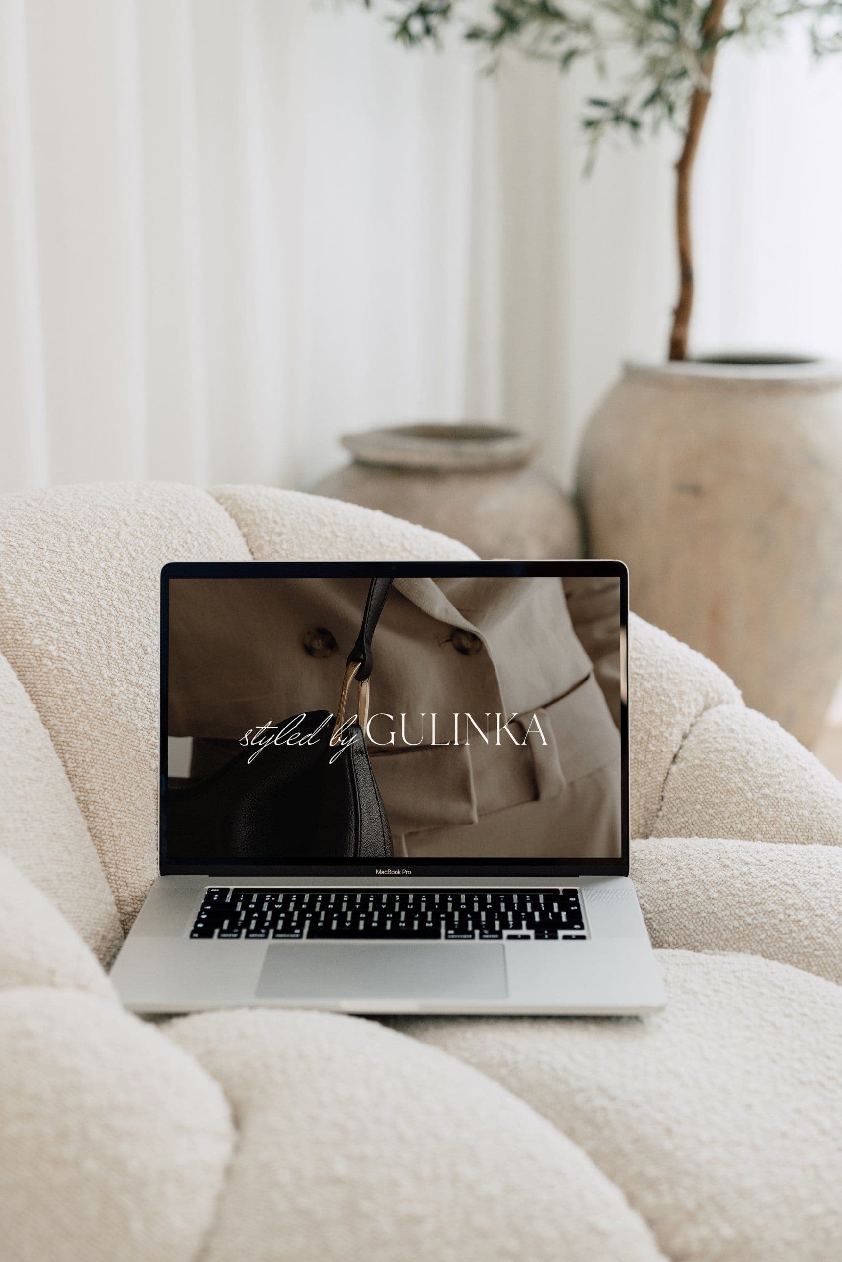 Gulinka smiling at her laptop during a virtual styling session
